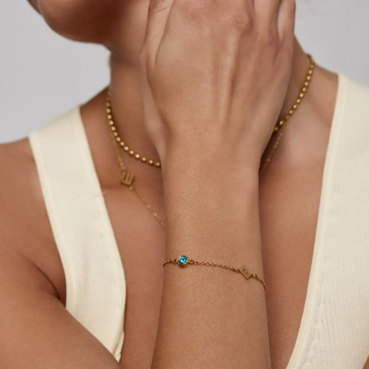 Initial birthstone bracelet lifestyle shot — Olivia Jewelry